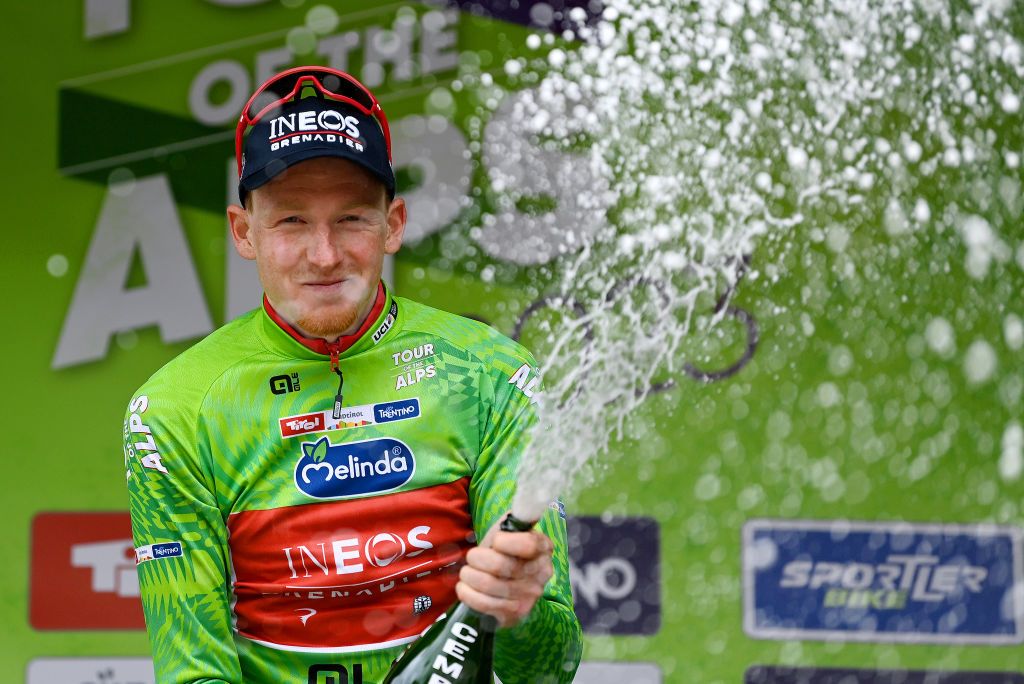 Tao Geoghegan Hart celebrates wearing the green leader&#039;s jersey at the Tour of the Alps