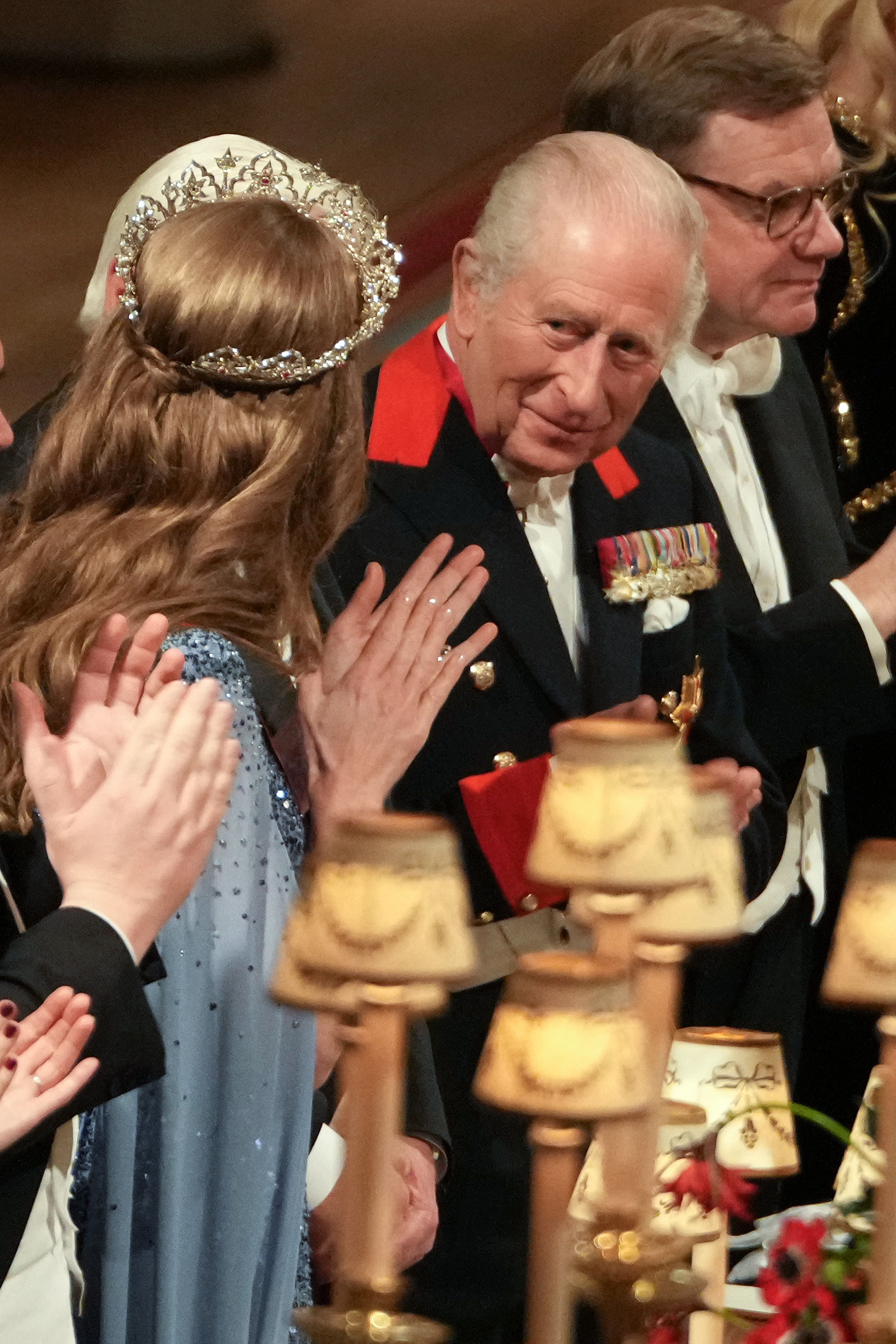 Kate Middleton clapping, wearing a tiara and looking at King Charles at a state banquet