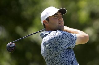 Scottie Scheffler hits a fairway wood