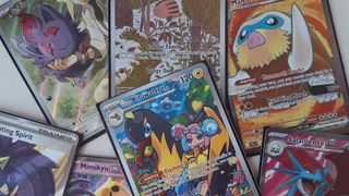 Pokemon Journey Together cards laid out in a pile on a white surface