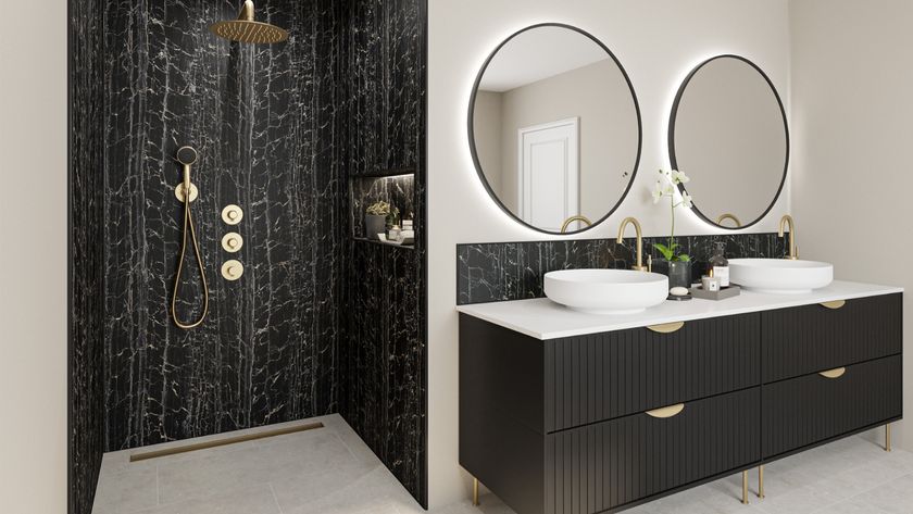 luxury looking bathroom with walk in shower clad in black marble effect wall panels, alongside black fluted vanity unit on one wall with double sinks and two circular mirrors