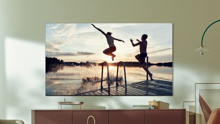 Best 65-inch TVs, Samsung Neo QLED TV wall-mounted above a wooden side table