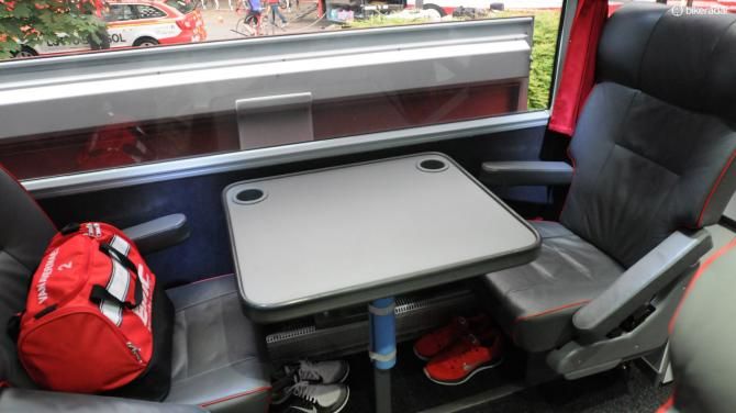 Another pair of facing seats with rider's casual footwear and spare kit bags
