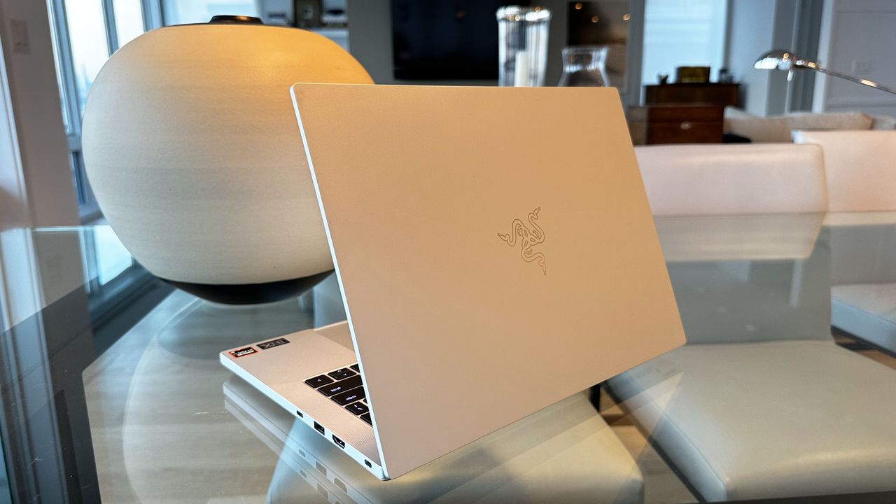 Razer Blade 14 (early 2024) angled on a glass desk showing the lid.