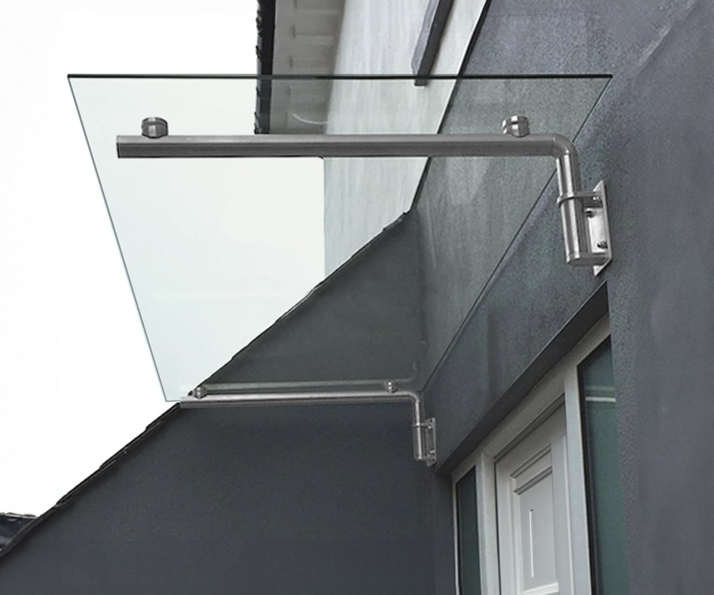 glass porch canopy on grey wall over white front door