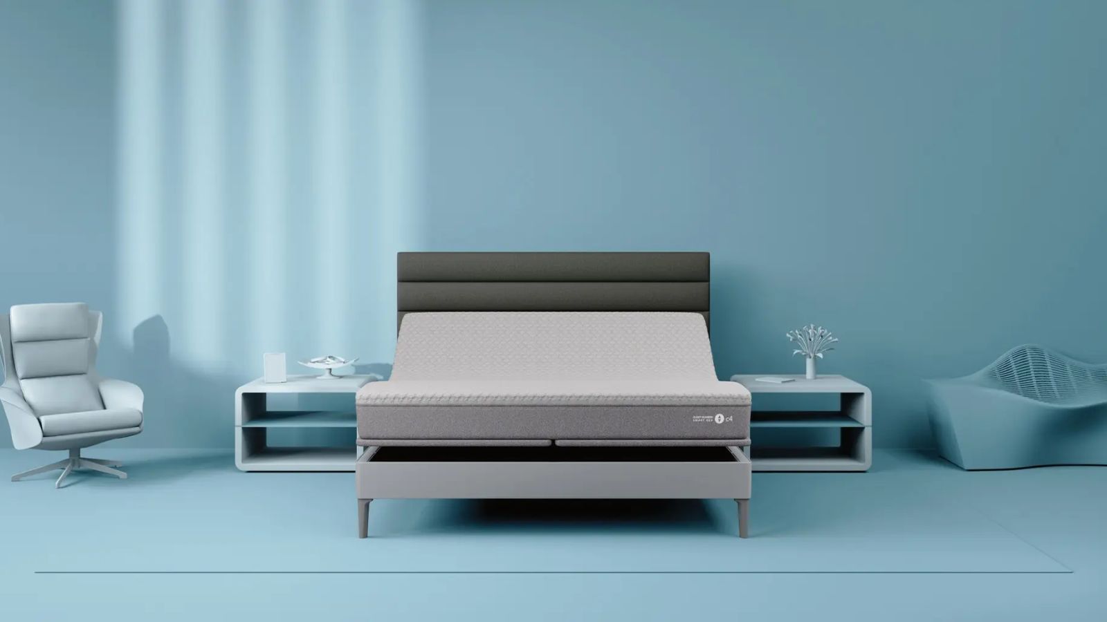 Sleep Number c4 mattress on a grey bedframe on a blue bedroom with blue nightstands, chair, sofa, and walls.