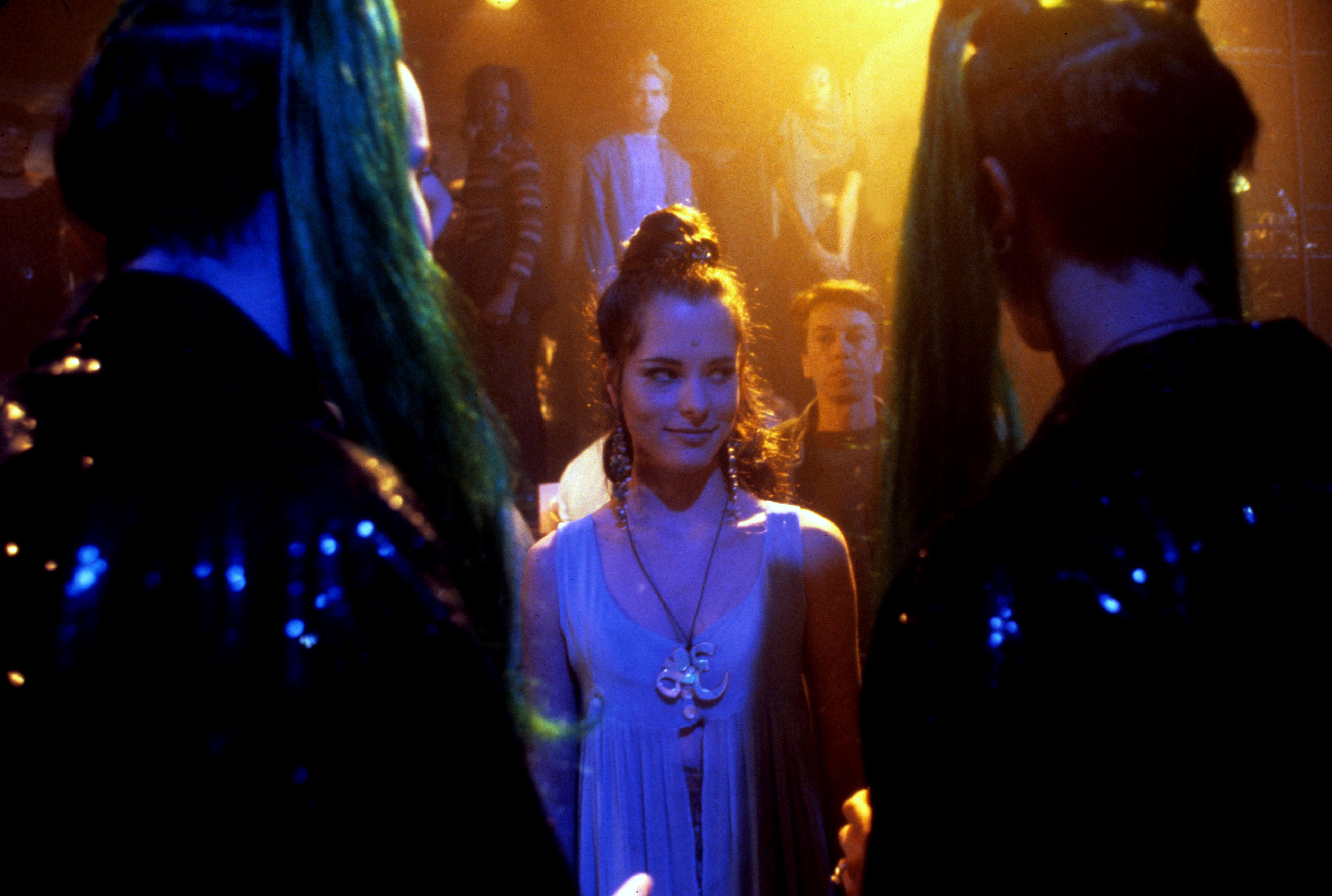 parker posey as mary with her hair in a bun at a party in the movie party girl