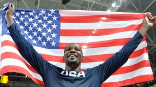 Kevin Durant holidng a USA flag after winning Olympics gold medal for basketball