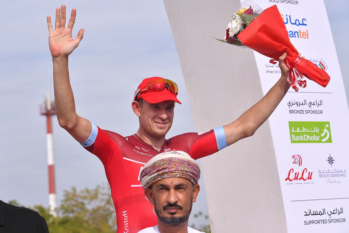 Alexander Kristoff on the podium, getting photobombed by one of the dignitaries