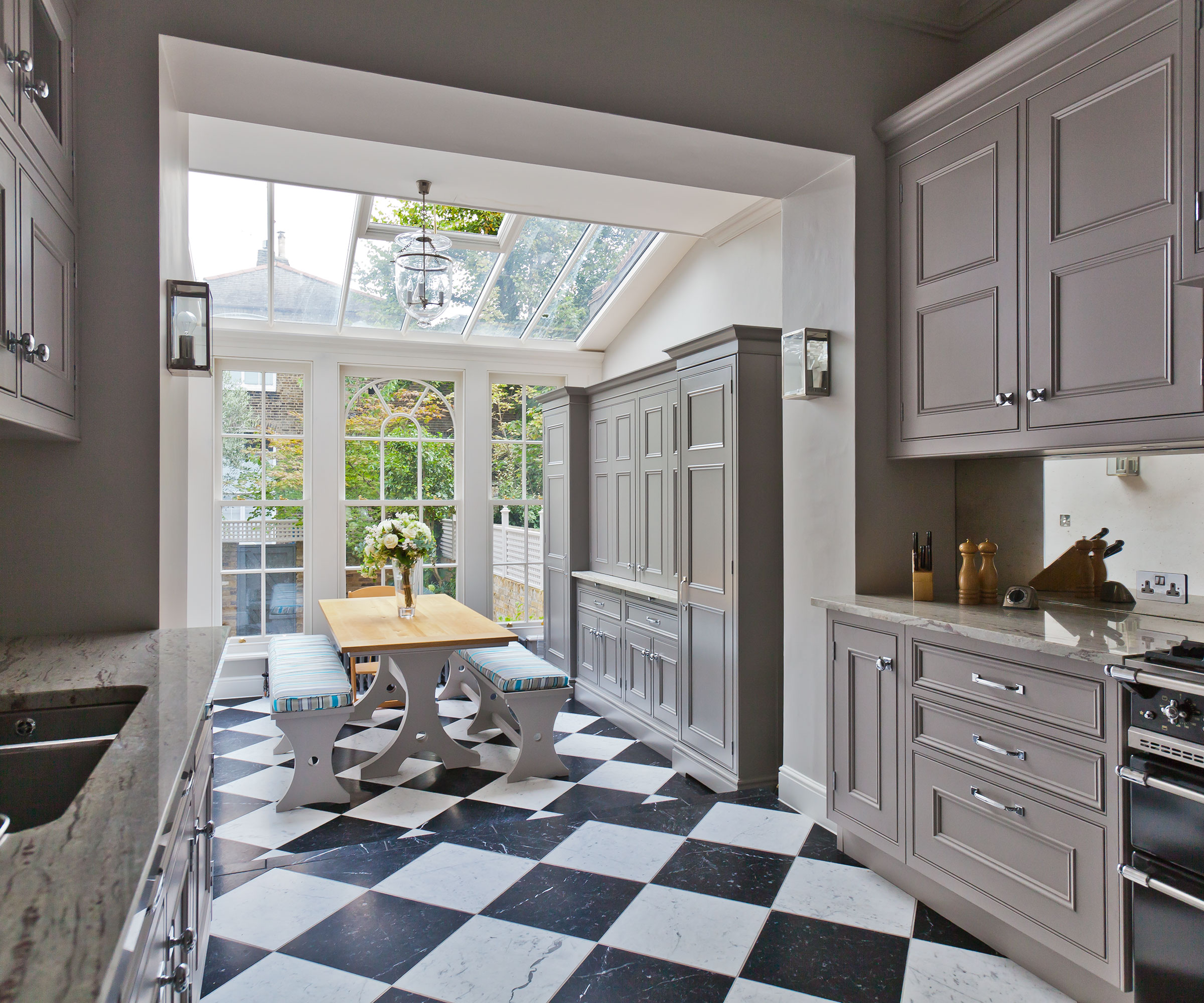 taupe kitchen orangery with black and white chequerboard flooring