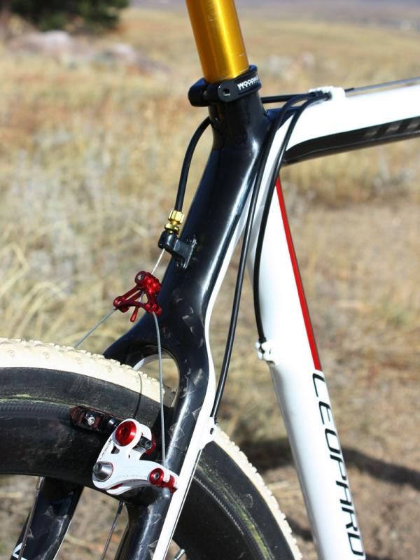 A stout housing stop and integrated barrel adjuster are included on the seat stay wishbone.