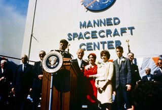 President John F. Kennedy honored astronaut John Glenn, who became the first American astronaut to orbit Earth in 1962, at what was then called NASA's Manned Spaceflight Center.