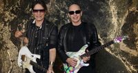 Steve Vai and Joe Satriani pictured with their signature Ibanez guitars