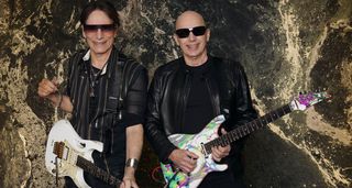Steve Vai and Joe Satriani pictured with their signature Ibanez guitars