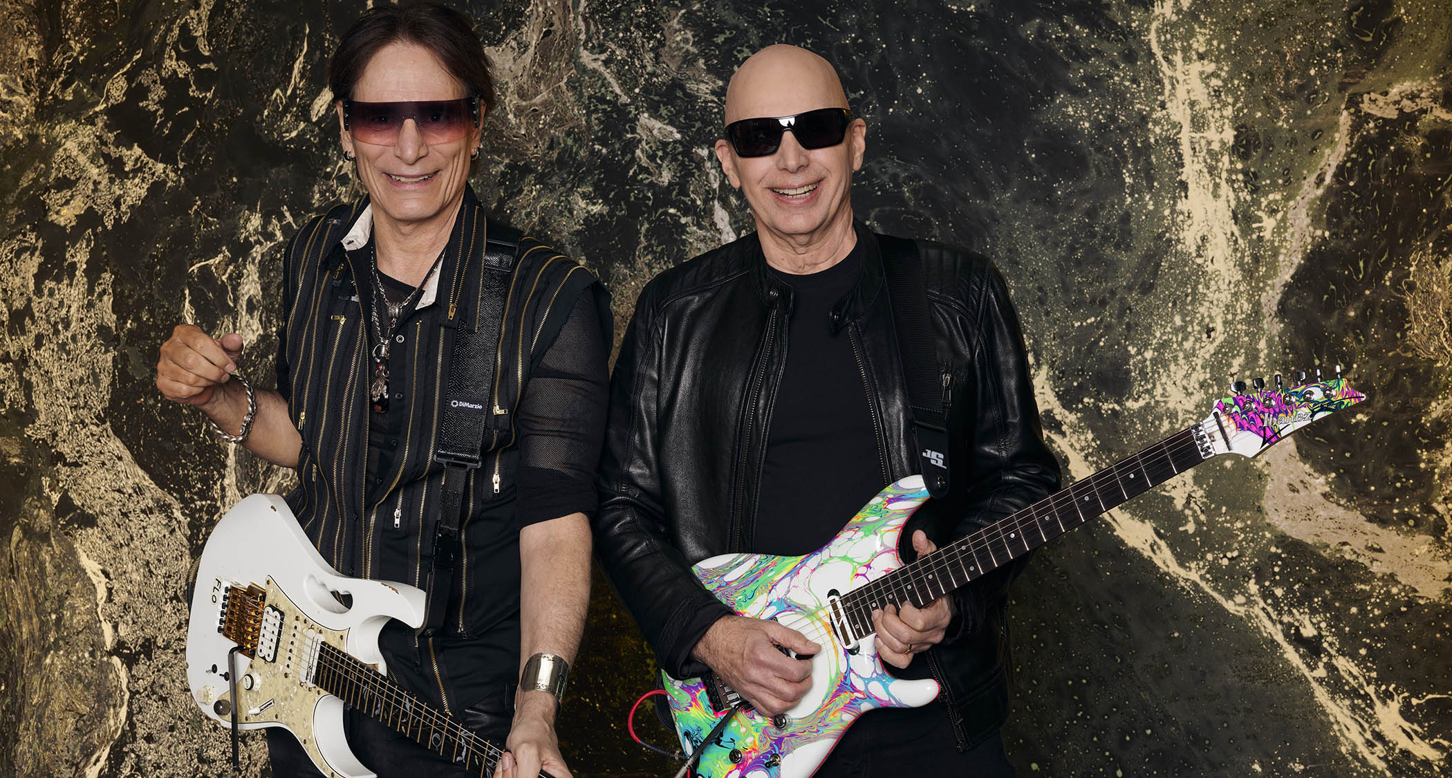 Steve Vai and Joe Satriani pictured with their signature Ibanez guitars