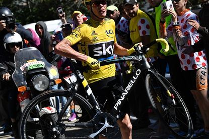 Chris Froome is forced to run with his bike during the Tour de France. 