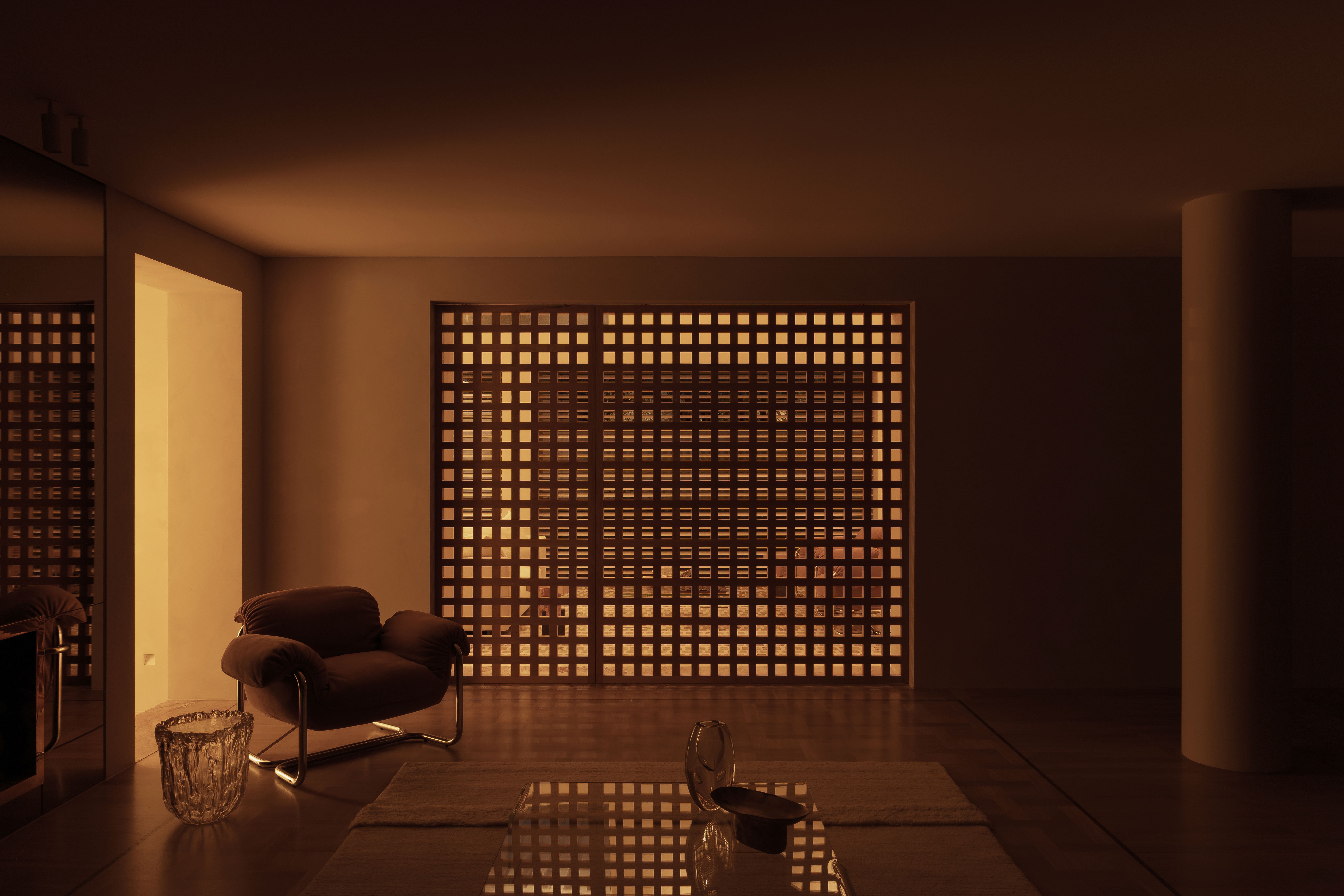 a residence in Australia, created from a midcentury house and a 1990s apartment building - seen here moody interior with a screen