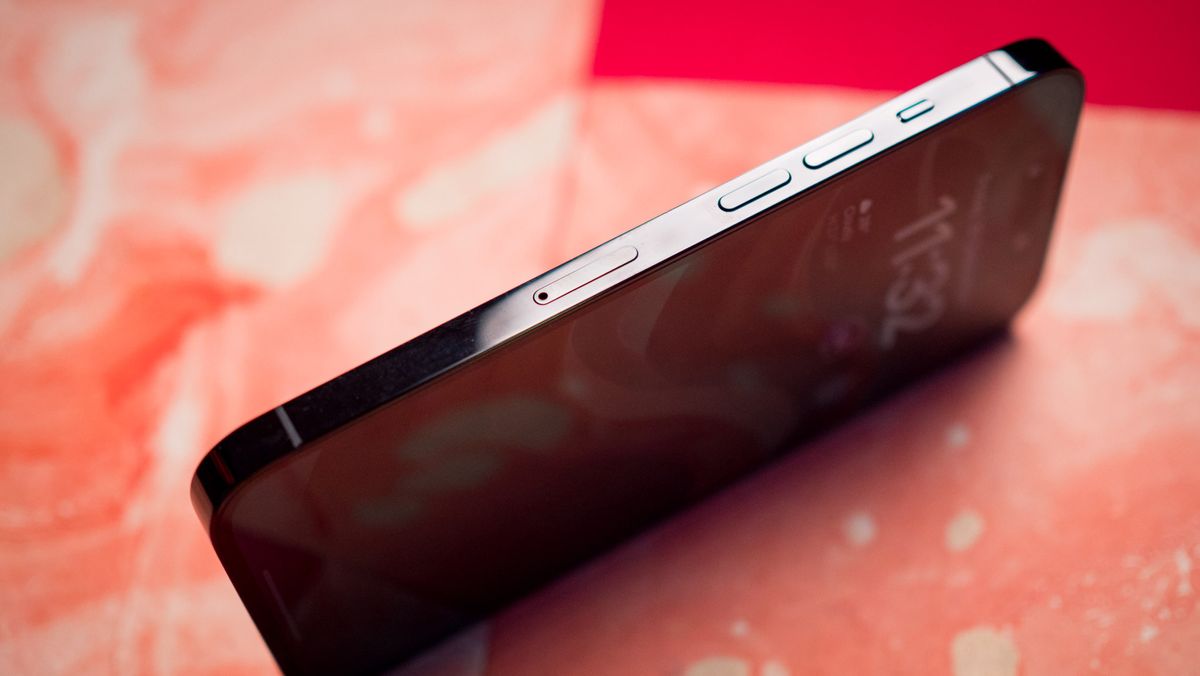 iPhone 14 Pro side view SIM card slot against red background