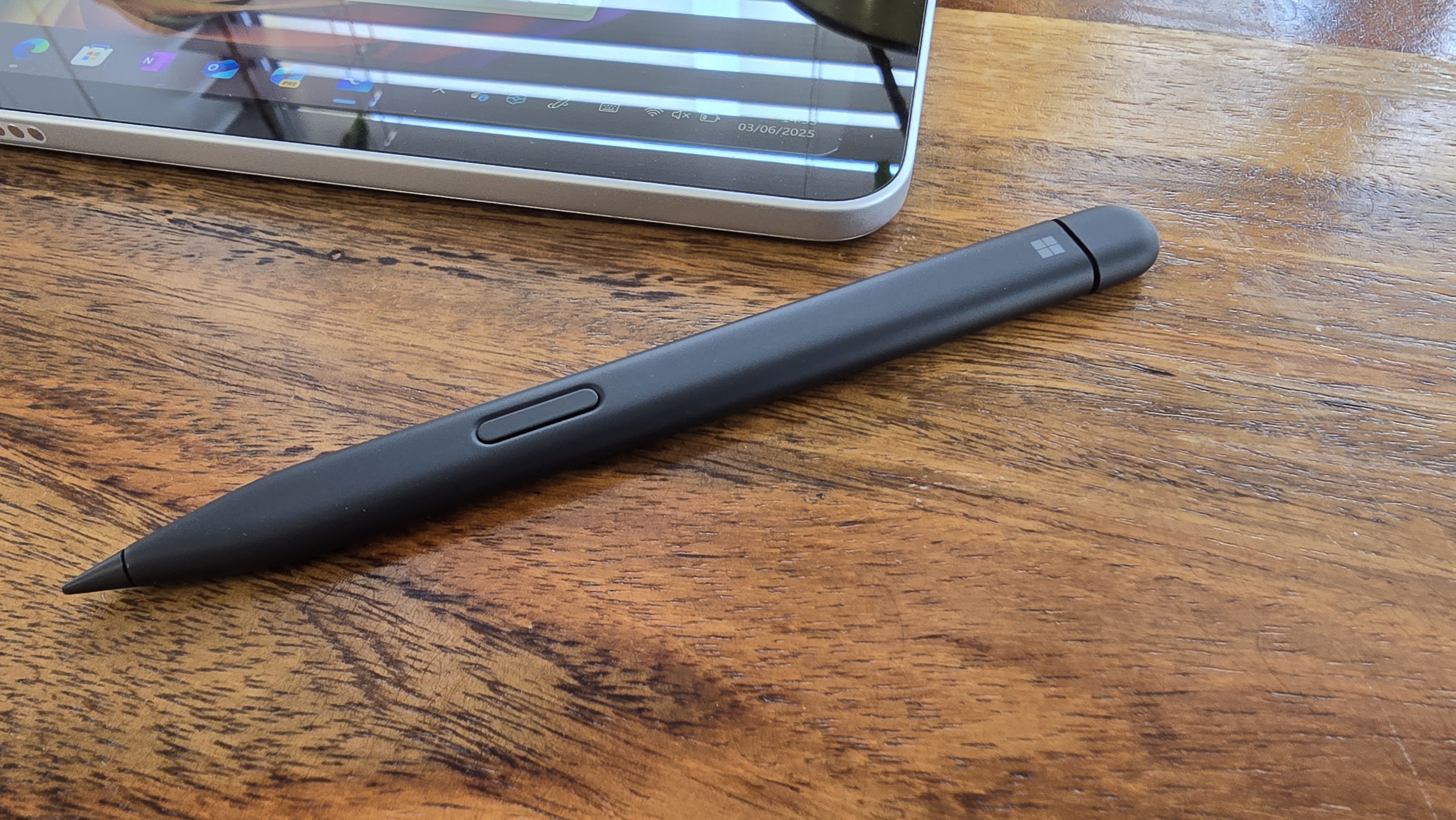 Microsoft Surface Pro 12 tablet on wooden table in relaxed cafe