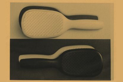 An image of black and white paddle hairbrushes