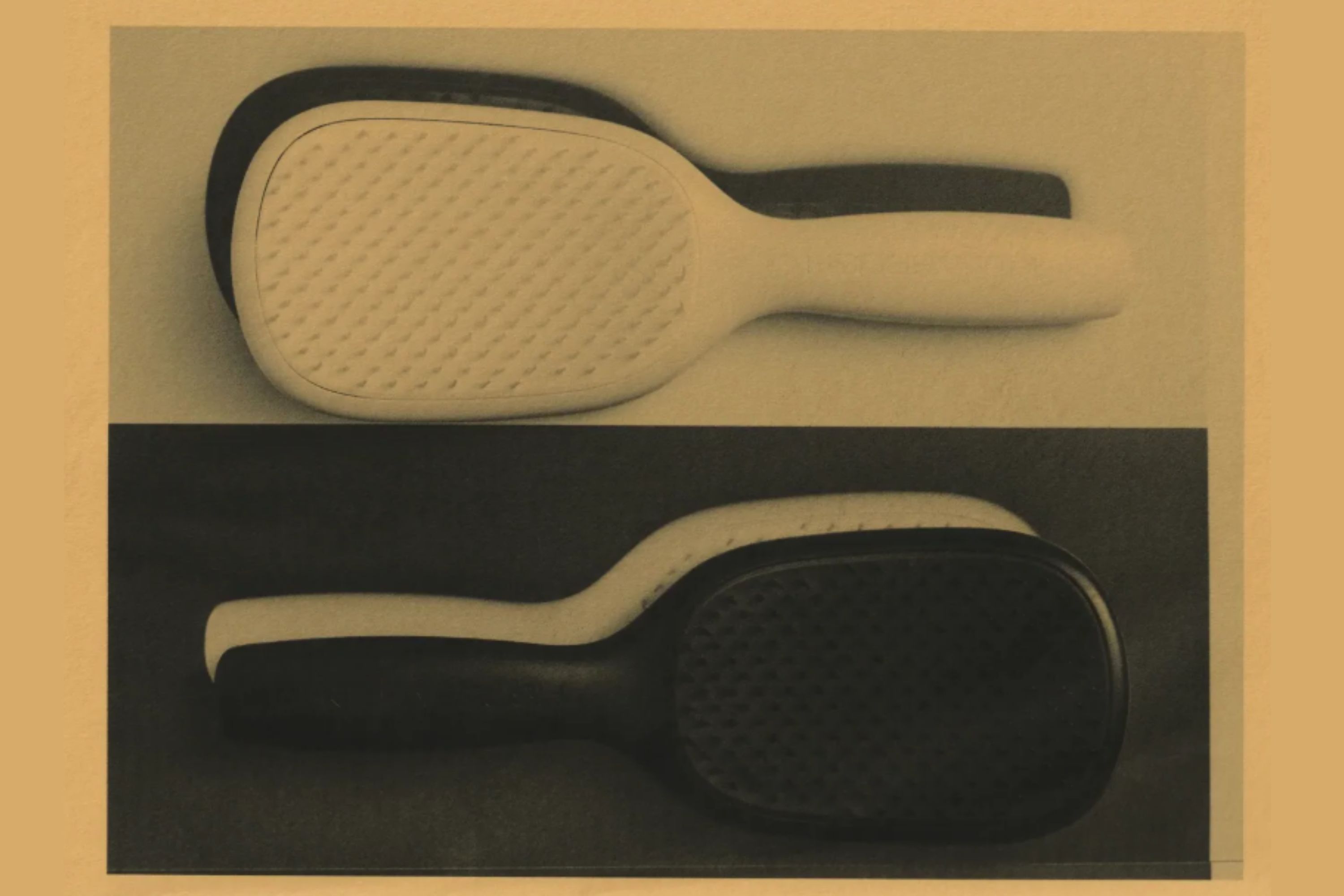 An image of black and white paddle hairbrushes