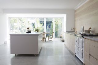 a kitchen with a concrete resin floor