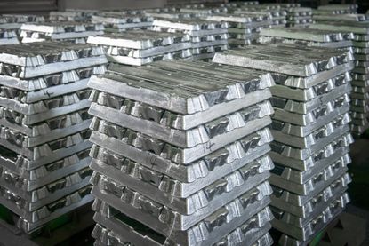Stacked ingots in aluminium recycling plant warehouse awaiting delivery