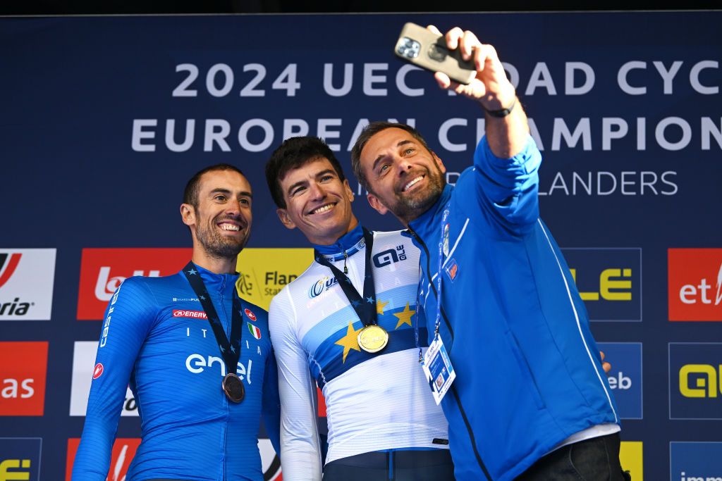 HASSELT BELGIUM SEPTEMBER 11 LR Bronze medalist Mattia Cattaneo of Team Italy gold medalist Edoardo Affini of Team Italy and Marco Velo Team Italy coach take a selfie on the podium during the medal ceremony after the 30th UEC Road Cycling European Championships 2024 Mens Elite Individual Time Trial a 313km from HeusdenZolder to Hasselt UCIWT on September 11 2024 in Hasselt Belgium Photo by Luc ClaessenGetty Images