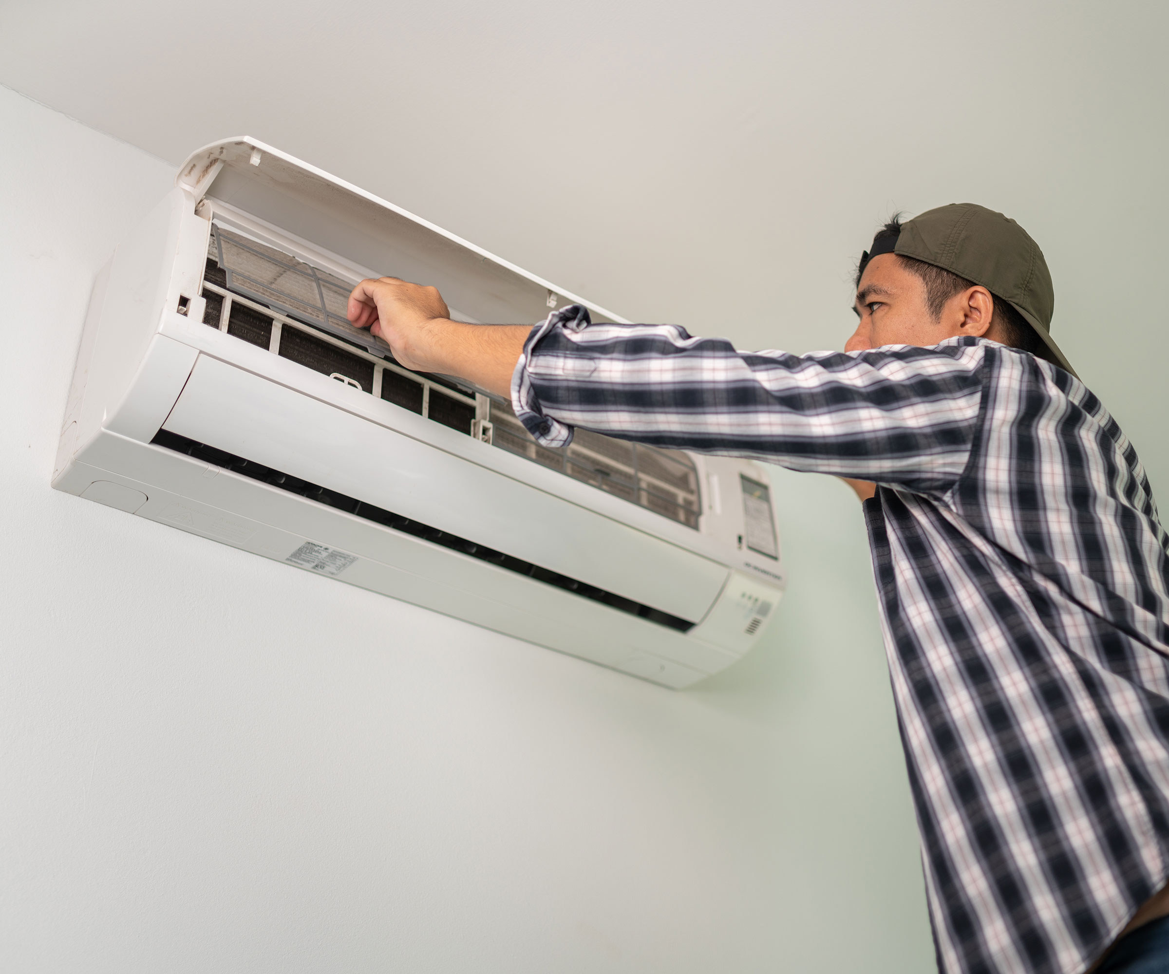 man installing wall mounted air conditioning