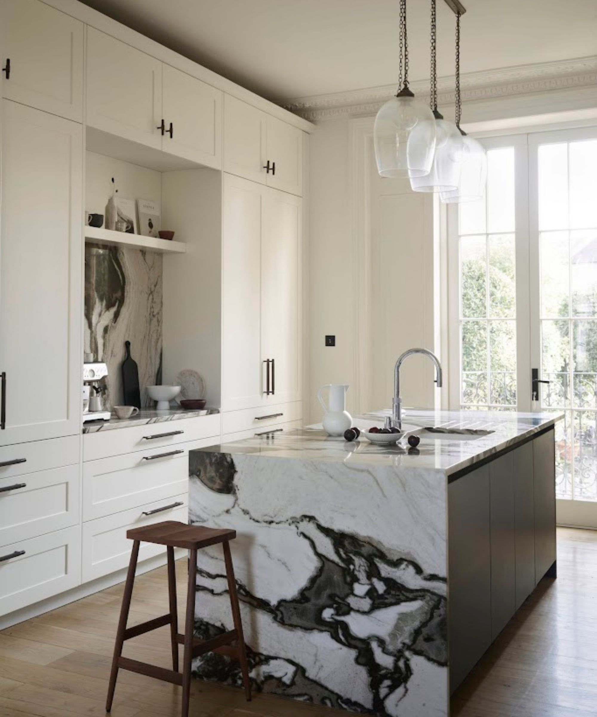 A white kitchen with statement marble countertops