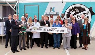 Administrators at Klein Independent School District stand proudly before the district’s mobile STEM lab
