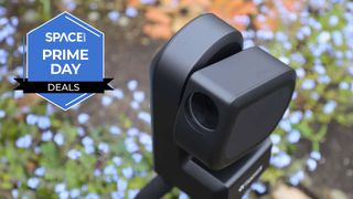 The ZWO Seestar S50 on a background of flowers with blue Space.com Prime Day badge in the upper-left corner.