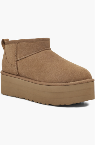 a pair of chunky ugg boots on a plain backdrop