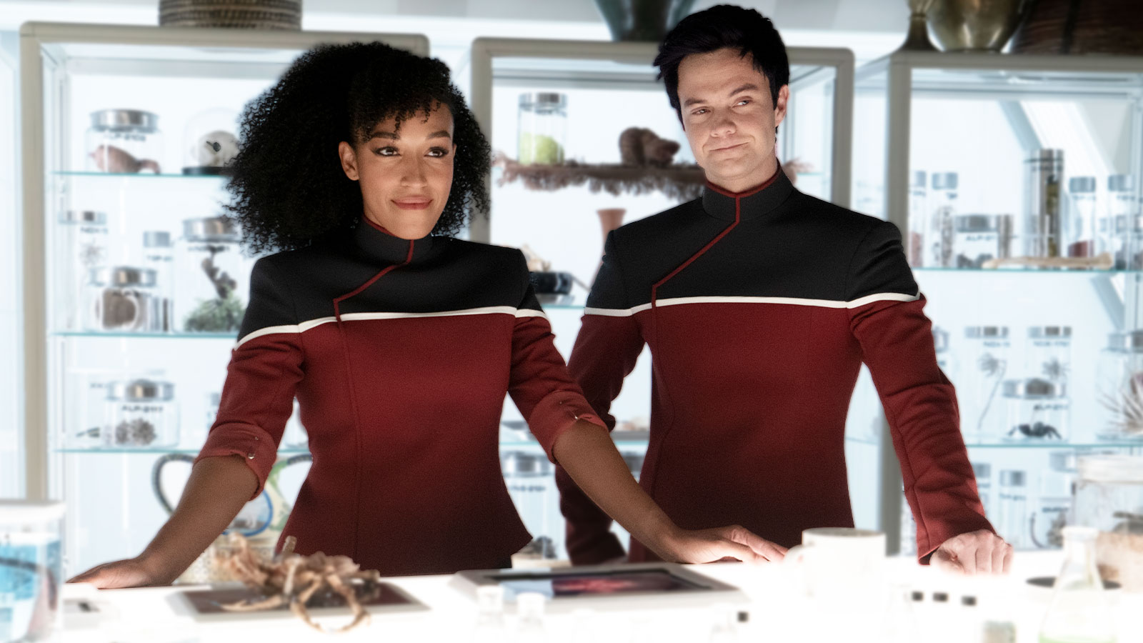 two characters in red starfleet uniforms on a spaceship