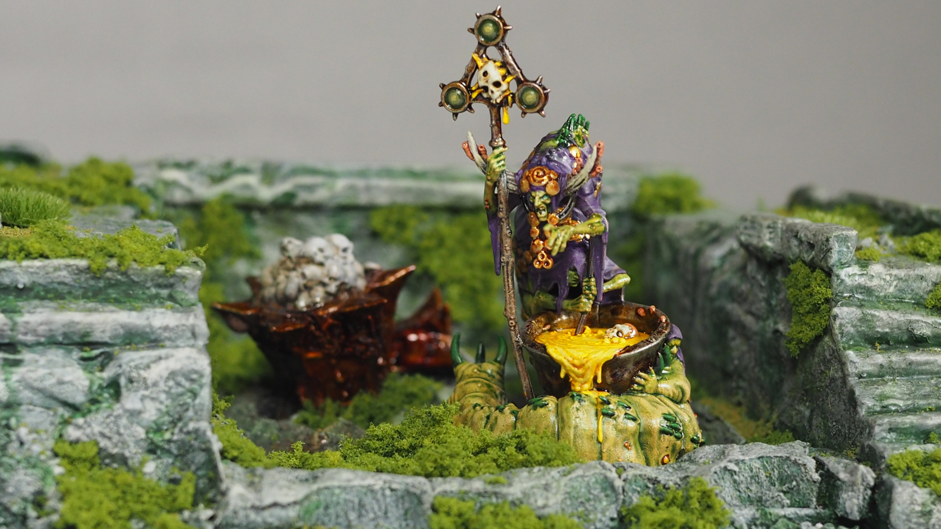 A Cystwitch model from Warhammer Quest: Darkwater, placed in a ruined, overgrown setting