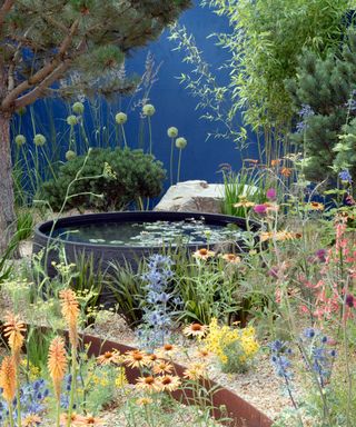 pond and blue wall at RHS Hampton Court 2022 garden