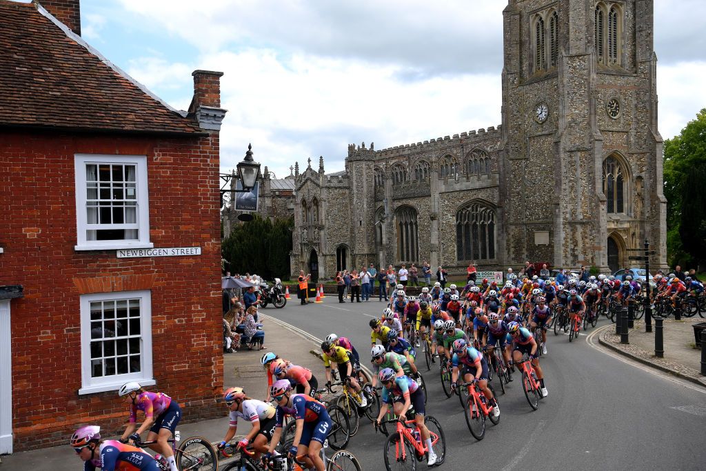 COLCHESTER ENGLAND MAY 24 LR Femke Markus of The Netherlands and Team SD WorxProtime Anastasia Carbonari of Italy and UAE Team Adq 06and a general view of the peloton passing Thaxted village during the 10th Ford RideLondon Classique 2024 Stage 1 a 1592km stage from Saffron Walden to Colchester UCIWWT on May 24 2024 in Colchester England Photo by Alex BroadwayGetty Images
