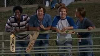 Ben Affleck, Cole Hauser, and other cast members of Dazed and Confused laugh and taunt baseball players from the stands