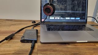Astell & Kern A&norma SR35 plugged into a laptop and headphones
