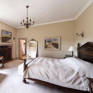 bedroom with white walls and brick fireplace