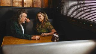 Robert Plant and Alison Krauss sitting in a diner