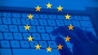 European union flag with a robot hand typing on a keyboard.