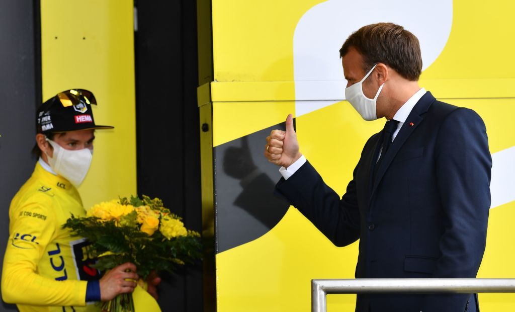 French President Emmanuel Macron greets Team Jumbo rider Slovenias Primoz Roglic wearing his overall leader yellow jersey on the podium atop the Loze pass Col de la Loze at the end of the 17th stage of the 107th edition of the Tour de France cycling race 170 km between Grenoble and Meribel on September 16 2020 Photo by Stuart Franklin various sources AFP Photo by STUART FRANKLINAFP via Getty Images