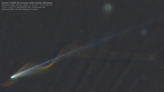 A comet is pictured with a bright nucleus in the lower right of an image against the blackness of space, with a long tail extending diagonally to the upper right of the shot. A spiral or light is pictured, appearing to wrap around the comet and its tail, created by the trail of a passing meteor.