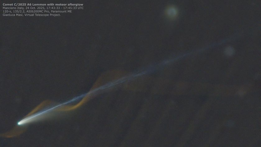 A comet is pictured with a bright nucleus in the lower right of an image against the blackness of space, with a long tail extending diagonally to the upper right of the shot. A spiral or light is pictured, appearing to wrap around the comet and its tail, created by the trail of a passing meteor.