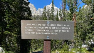 A trail sign from Grand Teton National Park's Facebook page instructing hikers to stick to the trails