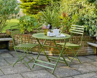 Brick built curved raised bed with bistro dining set