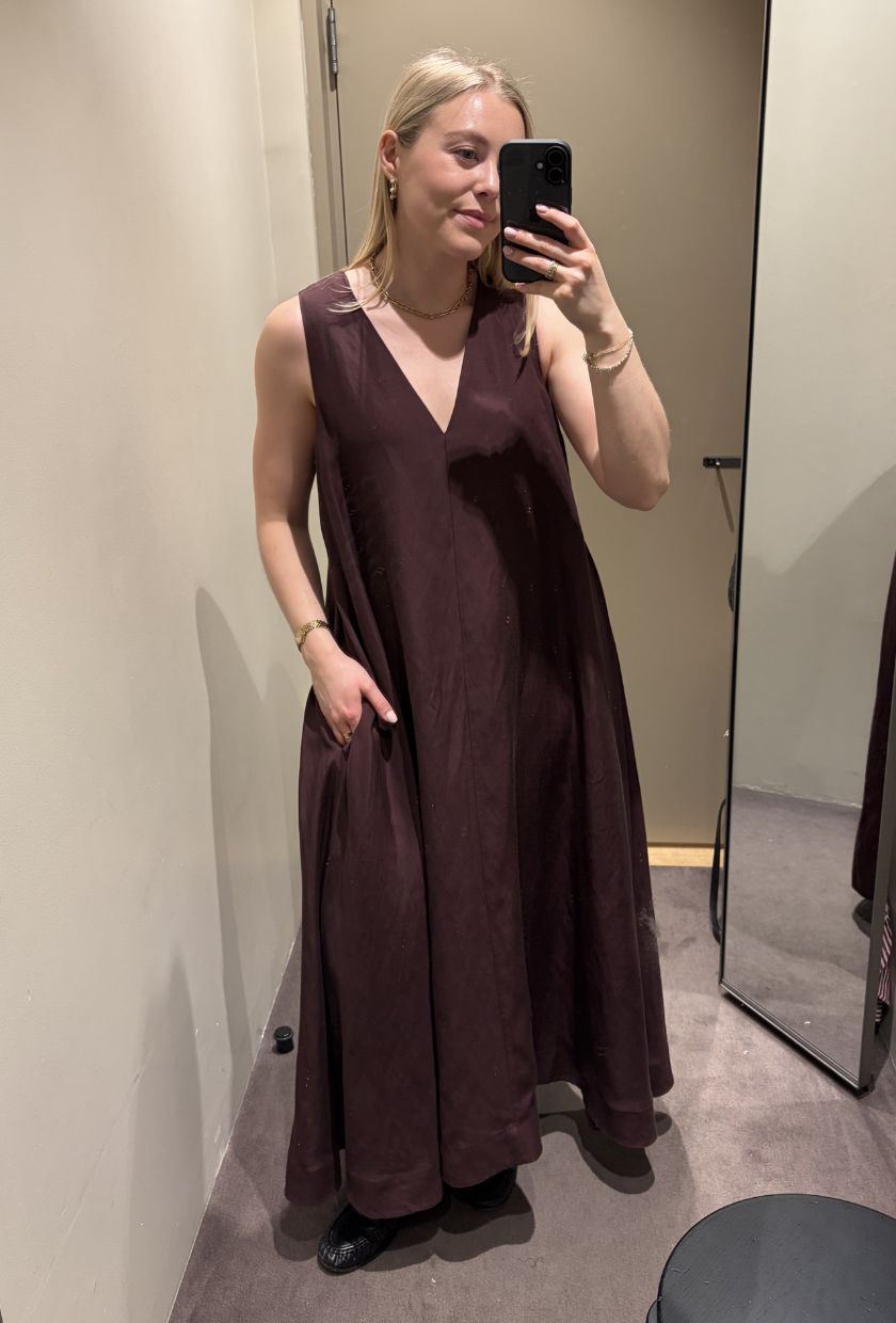 Woman wears burgundy maxi dress and loafers