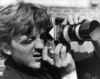 David Hemmings holding camera