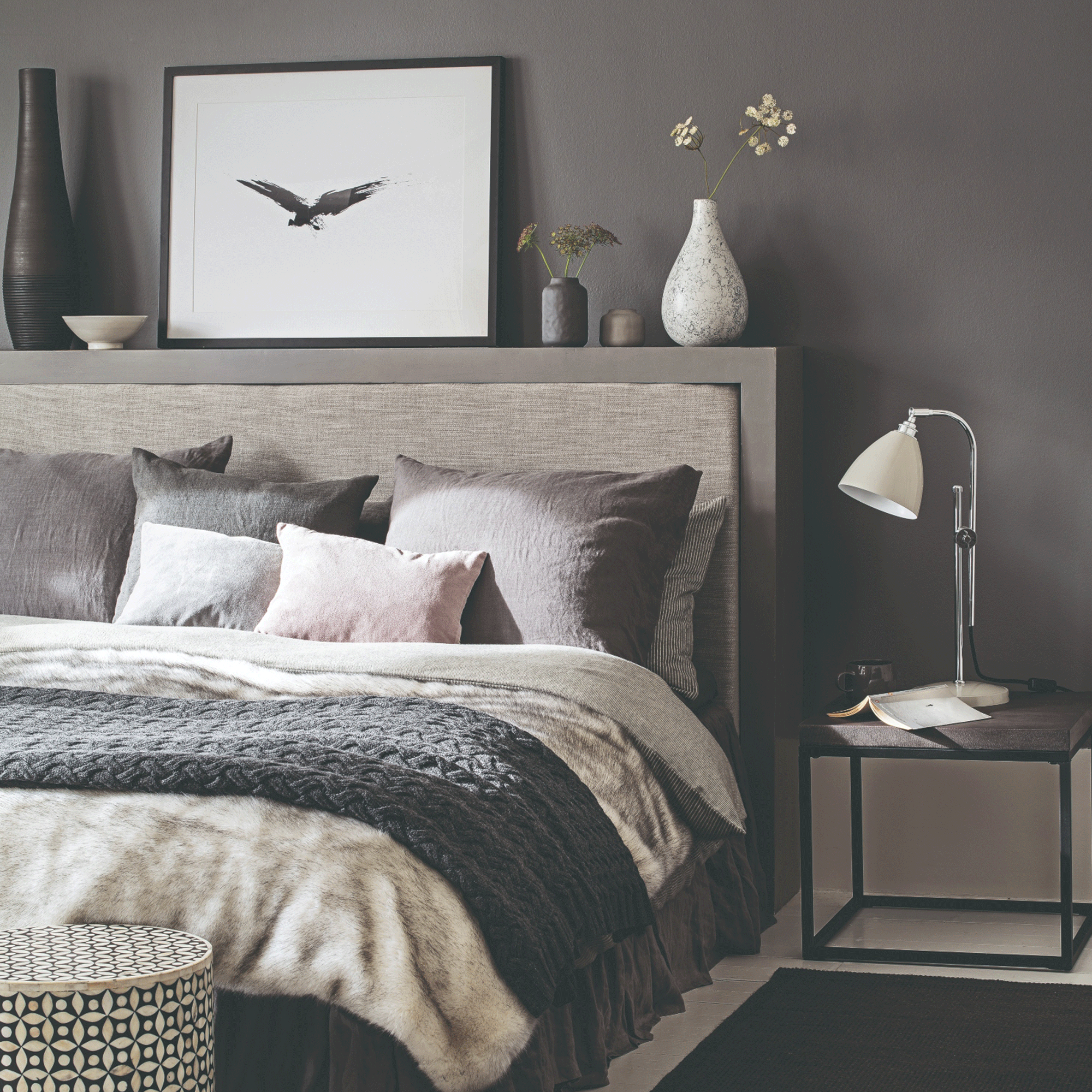 Grey bedroom with bed and side table
